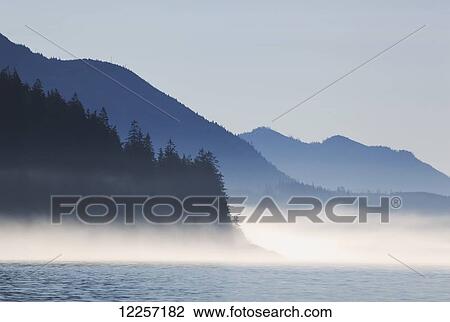 Stock Image - A foggy morning on Johnstone Strait on the coast; British Columbia, Canada. Fotosearch