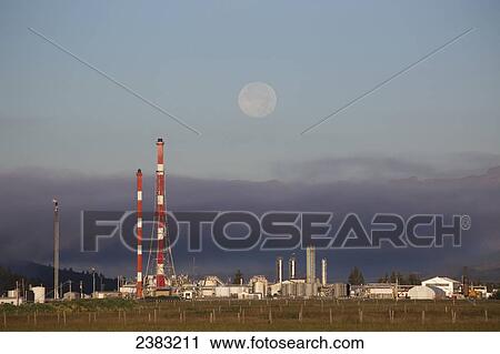 Stock Image - A full moon above a refinery. Fotosearch