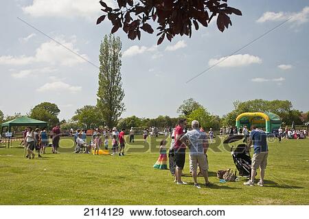 Stock Photo - A Gathering Of People On A Lawn In A Park; Claverdon Warwickshire England. Fotosearch