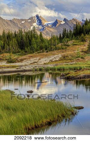 A Gentle Stream Flows Out Of Baker Lake Through The Skoki Wilderness In Banff National Park; Banff Alberta Canada View Large Photo Image Stock Photo - A Gentle Stream Flows Out Of Baker Lake Through The Skoki Wilderness In Banff National Park; Banff Alberta Canada. Fotosearch