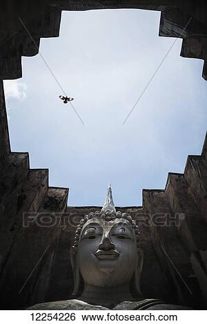 Stock Photograph - A giant enclosed Buddha in Sukhothai, central Thailand; Sukhothai, Thailand. Fotosearch