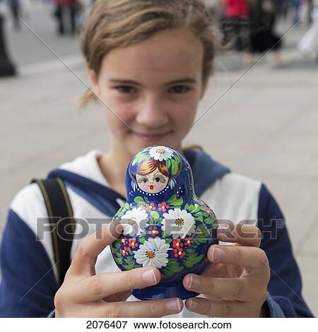 A Girl Holds A Matryoshka Nesting Doll; St. Petersburg Russia View Large Photo Image Stock Photo - A Girl Holds A Matryoshka Nesting Doll; St. Petersburg Russia. Fotosearch