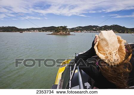 A Girl Holds Her Cowboy Hat On A Boat Cruise From Russell To Paihia; New Zealand View Large Photo Image Picture - A Girl Holds Her Cowboy Hat On A Boat Cruise From Russell To Paihia; New Zealand. Fotosearch