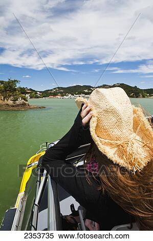 A Girl Holds Her Cowboy Hat On A Boat Cruise From Russell To Paihia; New Zealand View Large Photo Image Stock Photography - A Girl Holds Her Cowboy Hat On A Boat Cruise From Russell To Paihia; New Zealand. Fotosearch