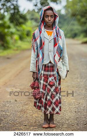 Stock Photo - A girl on her way to school on a rough road in the Highlands of Ethiopia; Ethiopia. Fotosearch