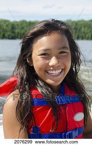 A Girl Wearing A Lifejacket; Lake Of The Woods Ontario Canada View Large Photo Image Stock Photo - A Girl Wearing A Lifejacket; Lake Of The Woods Ontario Canada. Fotosearch