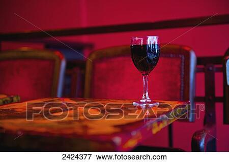 Stock Photo - A glass of red wine on a restaurant table; Paris, France. Fotosearch