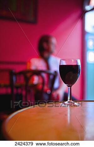 Stock Photo - A glass of red wine on a restaurant table; Paris, France. Fotosearch