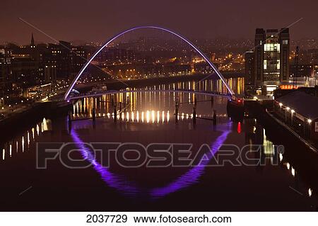Stock Photo - A Glowing Purple Arch On A Bridge Crossing River Tyne Illuminated At Night; Newcastle Northumberland England. Fotosearch
