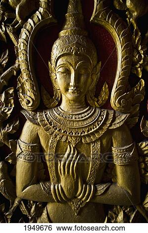 Stock Photograph - A Goddess Decorates The Doorway Of A Chiang Mai Wat; Chiang Mai Thailand. Fotosearch