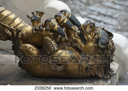A Gold And Black Sculpture Depicting A Claw Attacking A Smaller Animal; Beijing, China View Large Photo Image Stock Image - A Gold And Black Sculpture Depicting A Claw Attacking A Smaller Animal; Beijing, China. Fotosearch