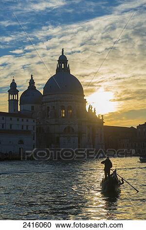 A gondolier in the grand canal with Salute church in the background; Venice, Veneto, Italy View Large Photo Image Stock Image - A gondolier in the grand canal with Salute church in the background; Venice, Veneto, Italy. Fotosearch