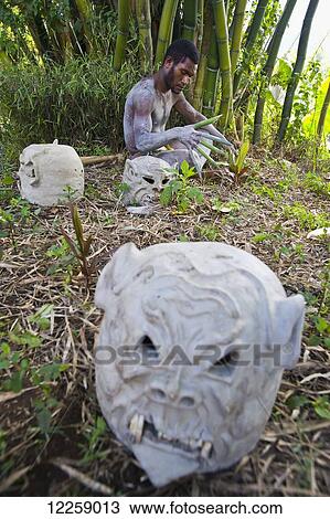 Stock Image - A Goroka Mudman relaxing in between performances; Goroka, Eastern Highlands, Papua New Guinea. Fotosearch