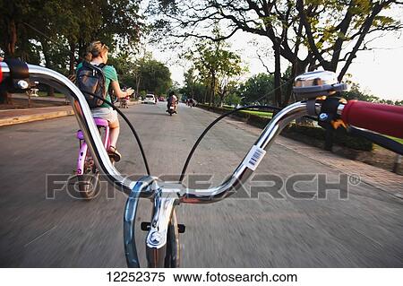 Stock Photography - A group goes to explore Thailand's old capital city of Sukhothai, with ancient relics in the Sukhothai historic park; Sukhothai, Thailand. Fotosearch