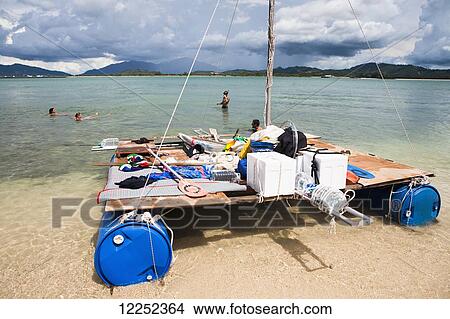 Picture - A group of backpackers decide to build their own raft and attempt to raft from Langkawi, Malaysia to Ko Lipe, Thailand; Cenang, Langkawi, Malaysia. Fotosearch