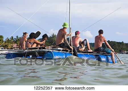A group of backpackers decide to build their own raft and attempt to raft from Langkawi, Malaysia to Ko Lipe, Thailand; Cenang, Langkawi, Malaysia View Large Photo Image Stock Photo - A group of backpackers decide to build their own raft and attempt to raft from Langkawi, Malaysia to Ko Lipe, Thailand; Cenang, Langkawi, Malaysia. Fotosearch