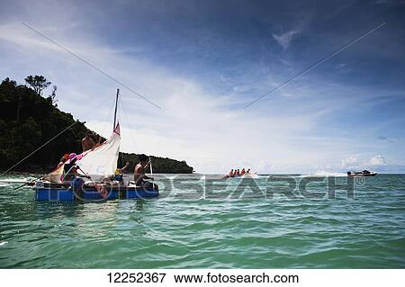A group of backpackers decide to build their own raft and attempt to raft from Langkawi, Malaysia to Ko Lipe, Thailand; Cenang, Langkawi, Malaysia View Large Photo Image Stock Photo - A group of backpackers decide to build their own raft and attempt to raft from Langkawi, Malaysia to Ko Lipe, Thailand; Cenang, Langkawi, Malaysia. Fotosearch