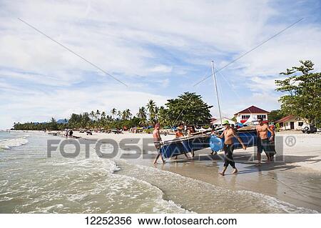 A group of backpackers decide to build their own raft and attempt to raft from Langkawi, Malaysia to Ko Lipe, Thailand; Cenang, Langkawi, Malaysia View Large Photo Image Stock Photograph - A group of backpackers decide to build their own raft and attempt to raft from Langkawi, Malaysia to Ko Lipe, Thailand; Cenang, Langkawi, Malaysia. Fotosearch