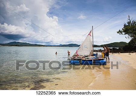 A group of backpackers decide to build their own raft and attempt to raft from Langkawi, Malaysia to Ko Lipe, Thailand; Cenang, Langkawi, Malaysia View Large Photo Image Stock Photography - A group of backpackers decide to build their own raft and attempt to raft from Langkawi, Malaysia to Ko Lipe, Thailand; Cenang, Langkawi, Malaysia. Fotosearch