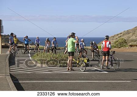 A group of cyclists preparing for a ride along the scenic coast; Honolulu, Oahu, Hawaii, United States of America View Large Photo Image Stock Photograph - A group of cyclists preparing for a ride along the scenic coast; Honolulu, Oahu, Hawaii, United States of America. Fotosearch