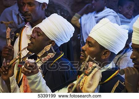 A group of men singing and playing instruments; Lalibela, Ethiopia View Large Photo Image Stock Photo - A group of men singing and playing instruments; Lalibela, Ethiopia. Fotosearch