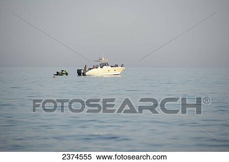 A group of people on a boat and jet ski; Puglia, Italy View Large Photo Image Stock Photography - A group of people on a boat and jet ski; Puglia, Italy. Fotosearch