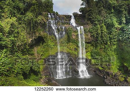 A group of travelers gather to play in the Tad Yuang Waterfall on the Bolaven Plateau; Laos View Large Photo Image Stock Image - A group of travelers gather to play in the Tad Yuang Waterfall on the Bolaven Plateau; Laos. Fotosearch