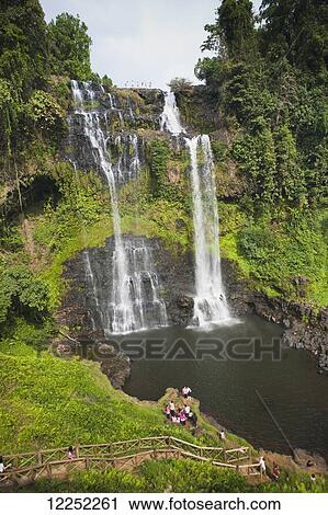 A group of travelers gather to play in the Tad Yuang Waterfall on the Bolaven Plateau; Laos View Large Photo Image Stock Image - A group of travelers gather to play in the Tad Yuang Waterfall on the Bolaven Plateau; Laos. Fotosearch