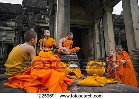 A group of young monks hang out at Angkor Wat; Siem Reap, Cambodia View Large Photo Image Stock Image - A group of young monks hang out at Angkor Wat; Siem Reap, Cambodia. Fotosearch