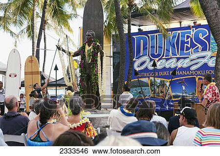 Stock Photograph - A group sits for a ceremony in a surfing culture; Honolulu, Oahu, Hawaii, United States of America. Fotosearch