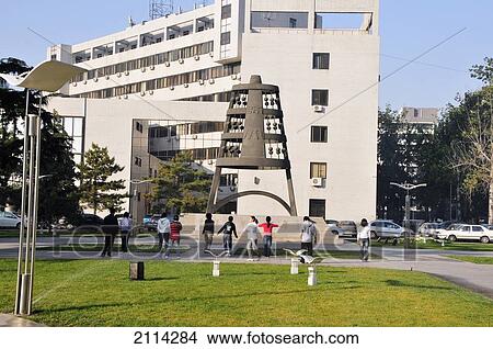 Picture - A Group Viewing A Sculpture In An Urban Park; Beijing China. Fotosearch