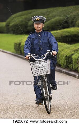 A Guard Riding A Bicycle Down A Path At The Imperial Palace; Tokyo, Japan View Large Photo Image Stock Image - A Guard Riding A Bicycle Down A Path At The Imperial Palace; Tokyo, Japan. Fotosearch