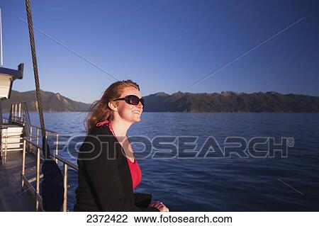 Stock Image - A Guest On The Real Journey Boat Touring Doubtful Sound; New Zealand. Fotosearch