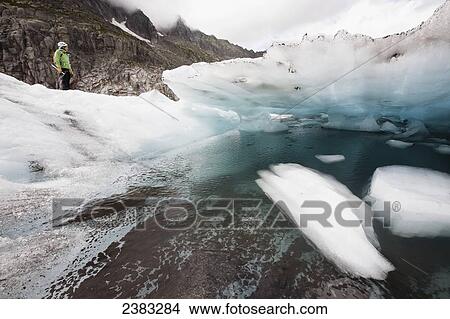 Picture - A guide on Mer de Glace (Sea of Ice) glacier using crampon and ice-axe techniques prior to attempt on climbing Mont Blanc; France. Fotosearch