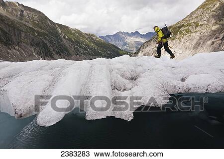 Stock Image - A guide on Mer de Glace (Sea of Ice) glacier using crampon and ice-axe techniques prior to attempt on climbing Mont Blanc; France. Fotosearch