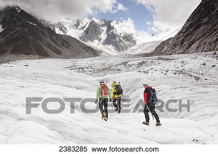Stock Photography - A guide on Mer de Glace (Sea of Ice) glacier teaching crampon and ice-axe techniques prior to attempt on climbing Mont Blanc; France. Fotosearch