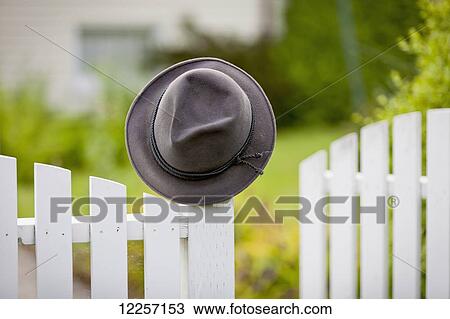 A hat hanging on the post of a white picket fence; Vancouver, British Columbia, Canada View Large Photo Image Stock Image - A hat hanging on the post of a white picket fence; Vancouver, British Columbia, Canada. Fotosearch