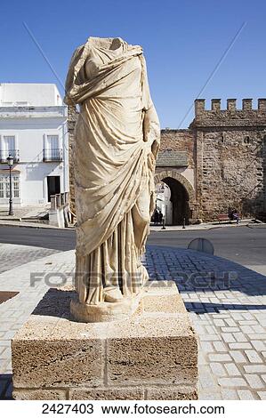 Stock Image - A headless statue of a woman at the entrance to Tarifa Town; Tarifa, Andalucia, Spain. Fotosearch
