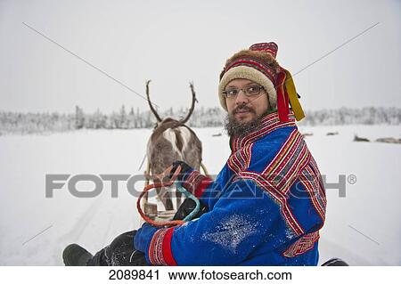 A Herder Wearing The Traditional Sami Clothing With Reindeer At Ounaskievari Reindeer Farm, Levi, Lapland, Finland View Large Photo Image Stock Image - A Herder Wearing The Traditional Sami Clothing With Reindeer At Ounaskievari Reindeer Farm, Levi, Lapland, Finland. Fotosearch