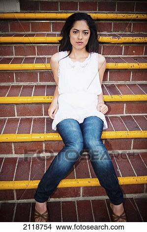 Picture - A High School Girl Sitting On Steps At The Balboa Fun Zone; Newport Beach California Usa. Fotosearch