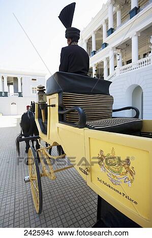 Stock Image - A horse and carriage outside Falaknuma Palace; Hyderabad, Andhra Pradesh, India. Fotosearch
