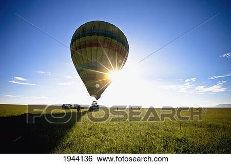 A Hot Air Balloon And A Vehicle In A Field; Kenya Africa View Large Photo Image Stock Photograph - A Hot Air Balloon And A Vehicle In A Field; Kenya Africa. Fotosearch