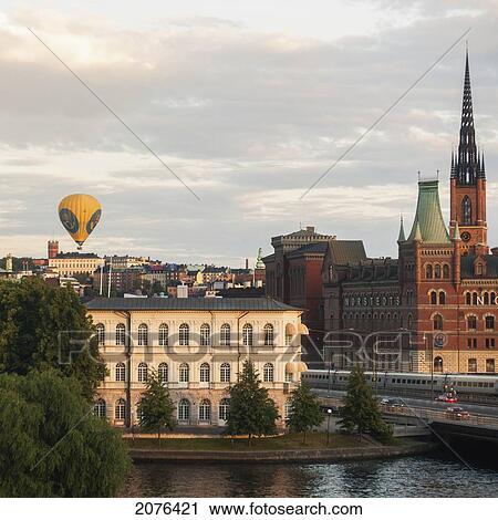 Stock Image - A Hot Air Balloon Floating Above The Buildings; Stockholm Sweden. Fotosearch