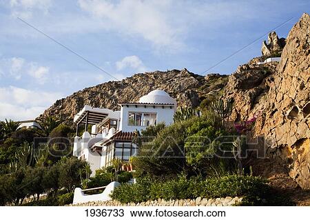 A House Against A Rock Cliff Near Zahara De Los Atunes; Andalusia Spain View Large Photo Image Stock Image - A House Against A Rock Cliff Near Zahara De Los Atunes; Andalusia Spain. Fotosearch