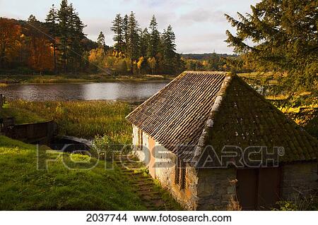Picture - A House Along The River In Autumn; Northumberland England. Fotosearch