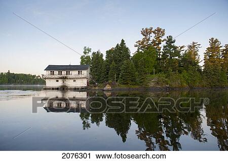 A House Along The Water's Edge; Lake Of The Woods Ontario Canada View Large Photo Image Stock Image - A House Along The Water's Edge; Lake Of The Woods Ontario Canada. Fotosearch