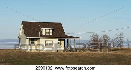 Stock Image - A house on the water's edge, Hecla-Grindstone Provincial Park; Manitoba, Canada. Fotosearch