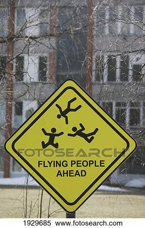 Stock Photography - A humorous sign depicting flying people ahead; Riga, Latvia. Fotosearch