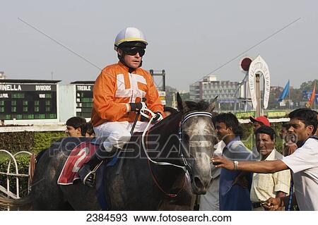 Stock Image - A jockey on a horse at Calcutta race course during the March St Leger meeting; Calcutta, West Bengal State, India. Fotosearch