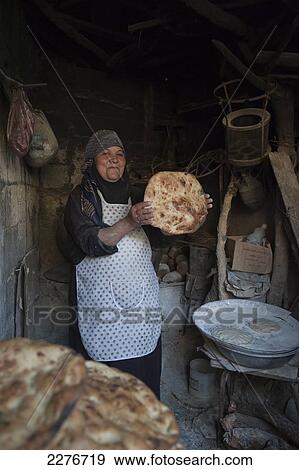 Stock Photo - A Jordanian woman baker, near Al Ayoun trail; Jordan. Fotosearch